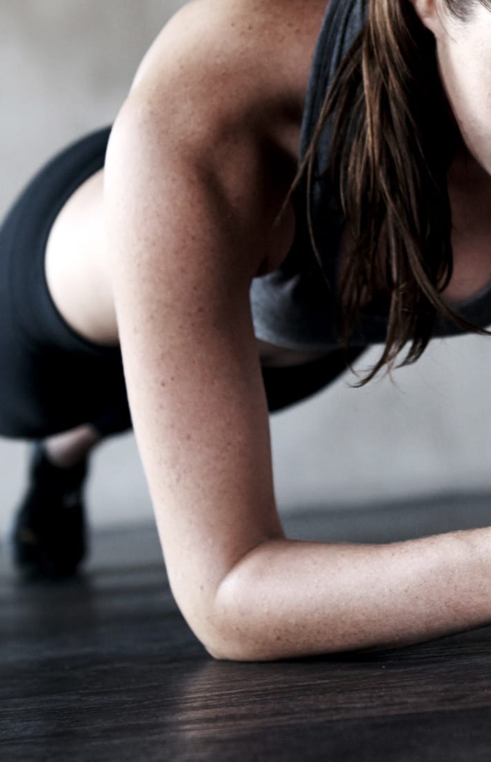 Close of of the arm of a woman planking