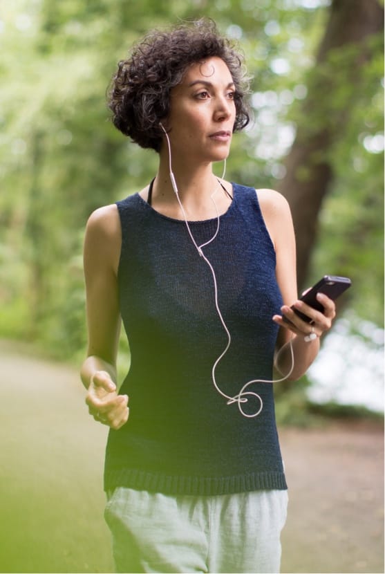 Woman walking while holding phone