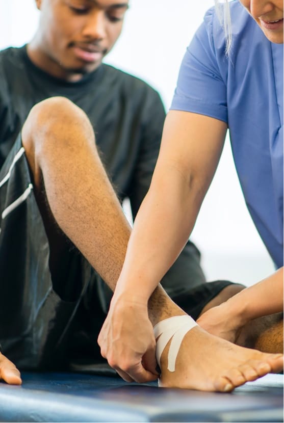 Male patient getting ankle taped
