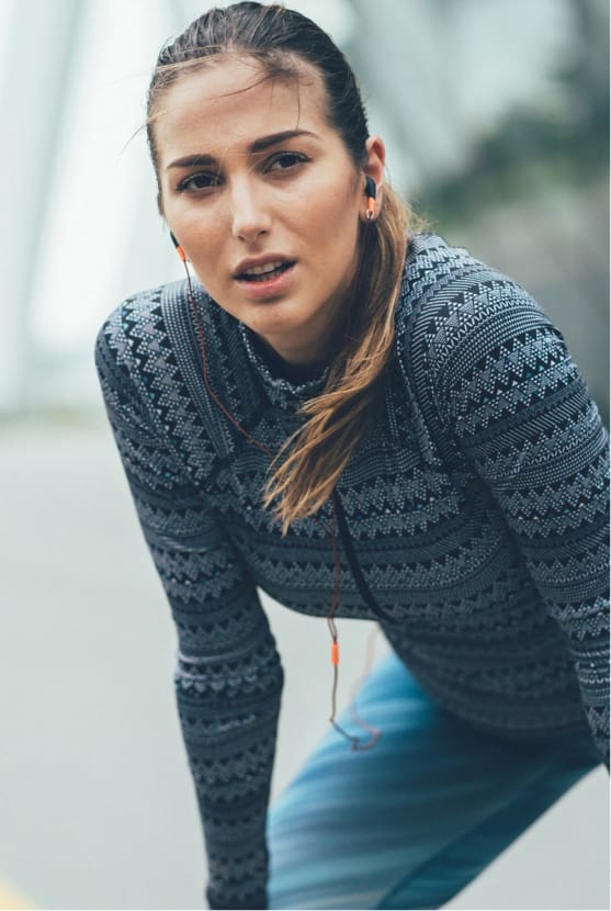 Woman pausing during a run outside