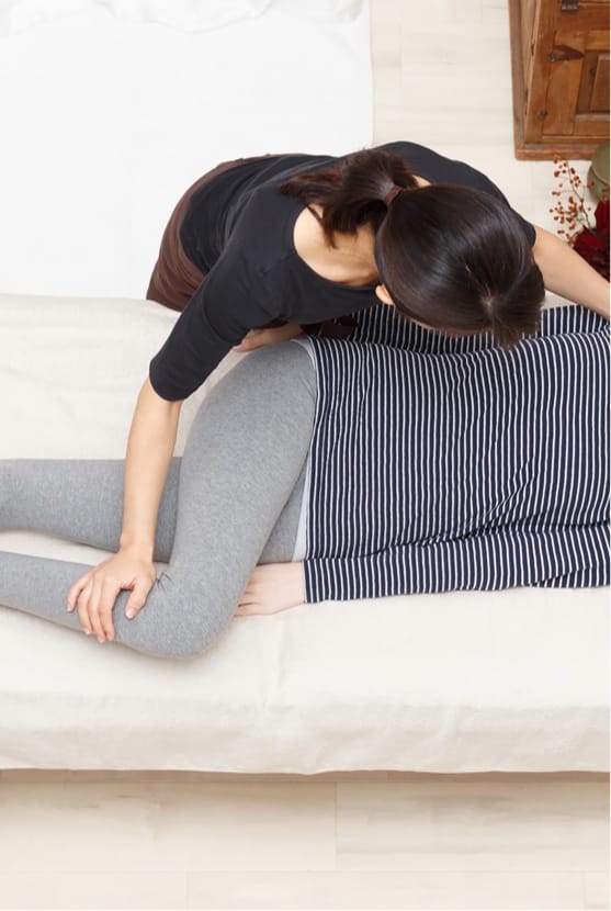 Professional helping patient with a shoulder stretch