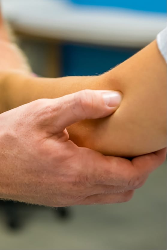 Doctor's hand pressing on patients elbow