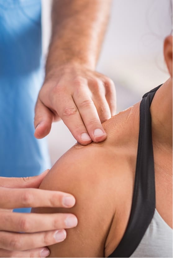 Professional massaging patient's shoulder