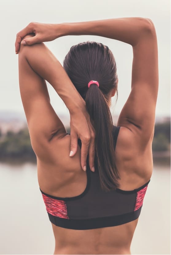 Woman stretching arm outside