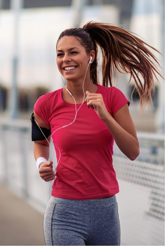 Woman smiling, running outside