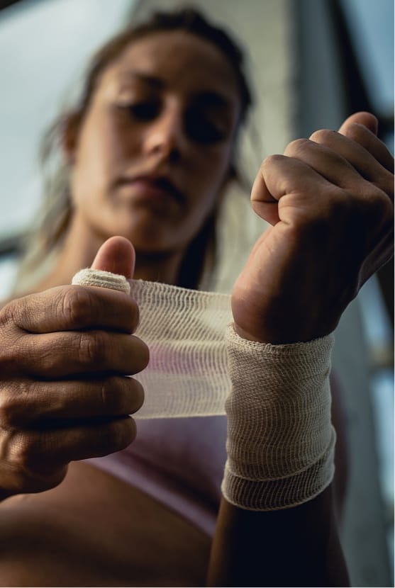 Woman wrapping wrist before working out